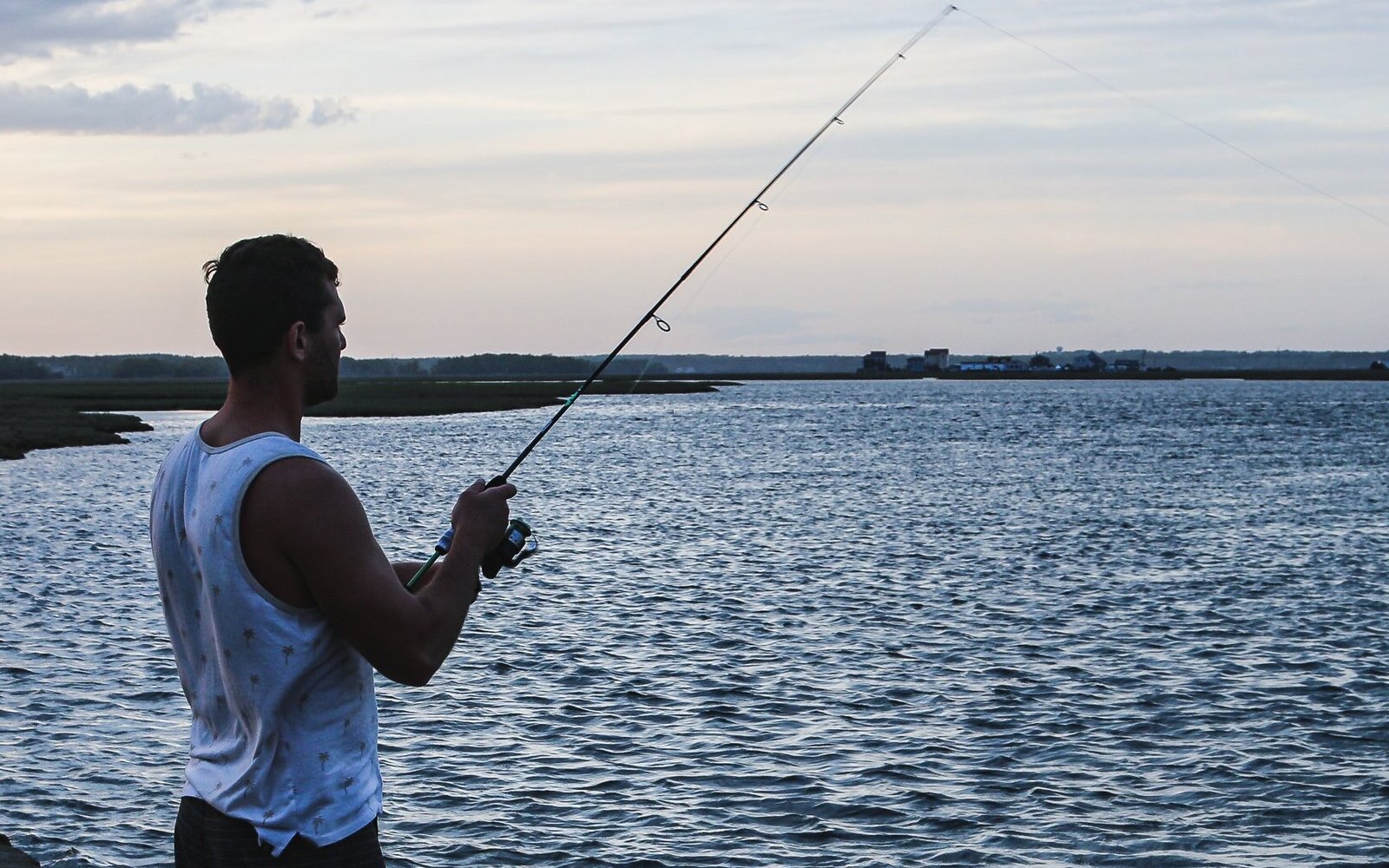 person fishing on new hampshire shore